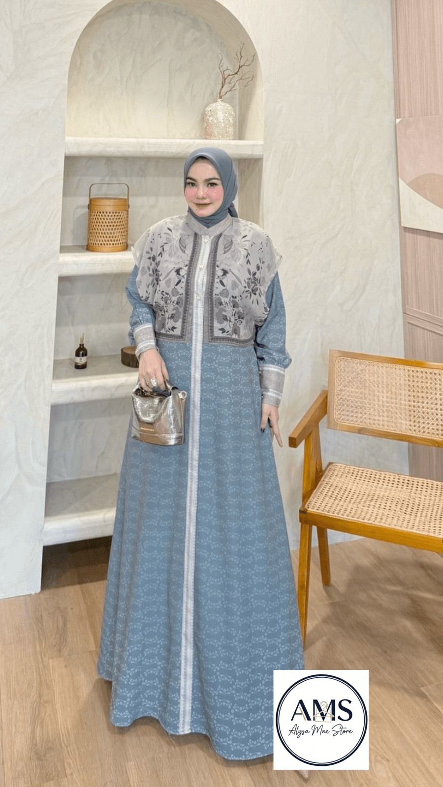 Elliora Dress V4 displayed by a model, showcasing timeless elegance and sophisticated design in soft blue tones.