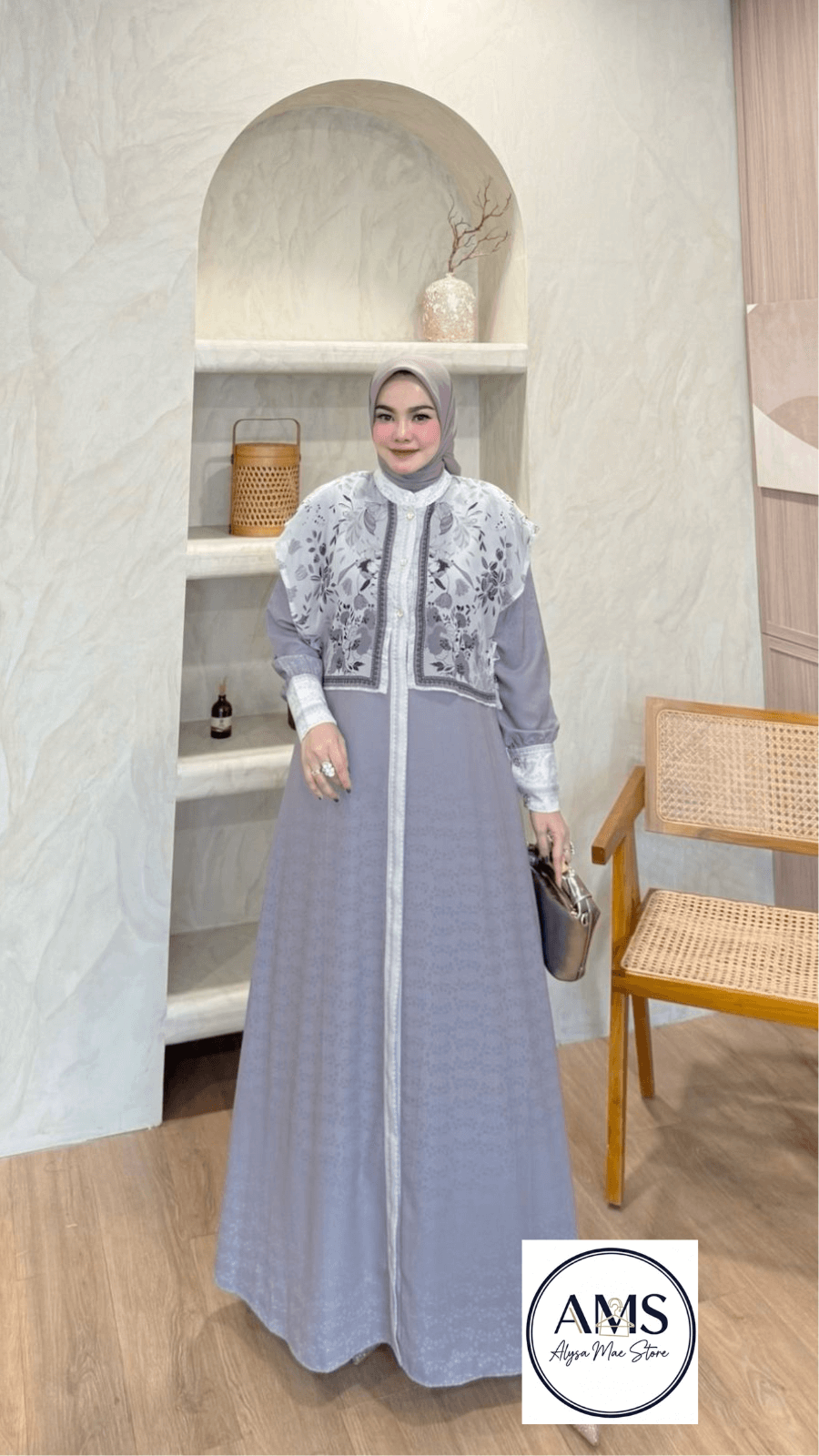 A woman wearing the Elliora Dress V4 in gray, showcasing its elegant design and intricate detailing.